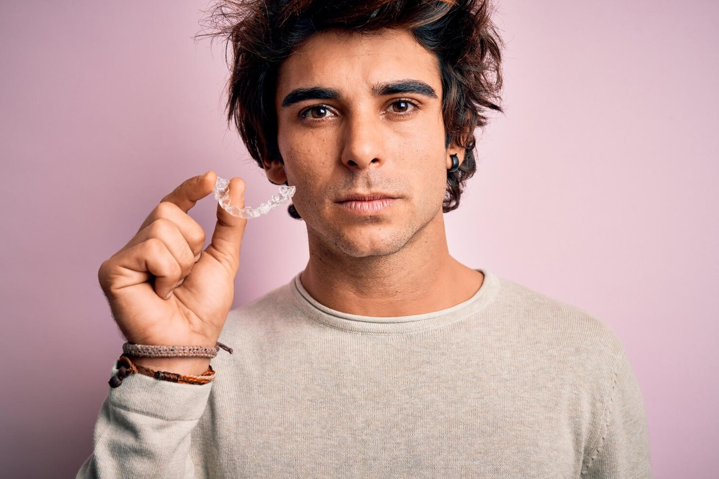 Man Holding Clear Aligners