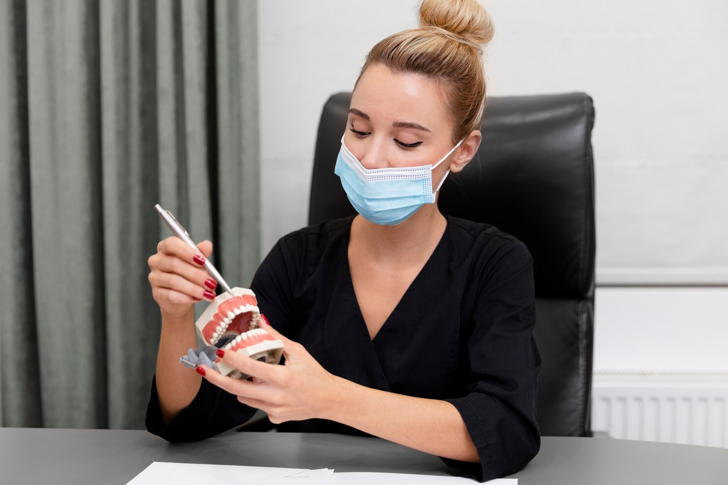 Doctor holding dentures