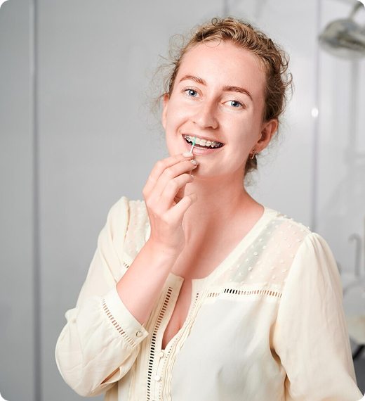 Woman Cleaning Her Braces